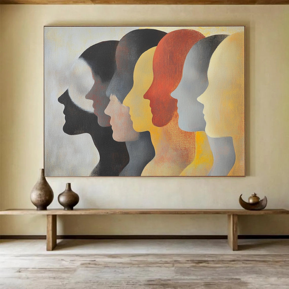 Large abstract painting featuring faces in profile with diverse skin tones and hairstyles in soft colors on a light background.SC548
