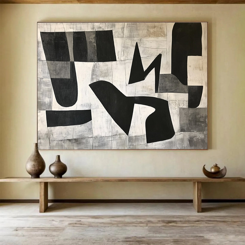 Large abstract painting featuring black and white geometric shapes in the letter K on a textured minimalist background conveying depth and movementSC517