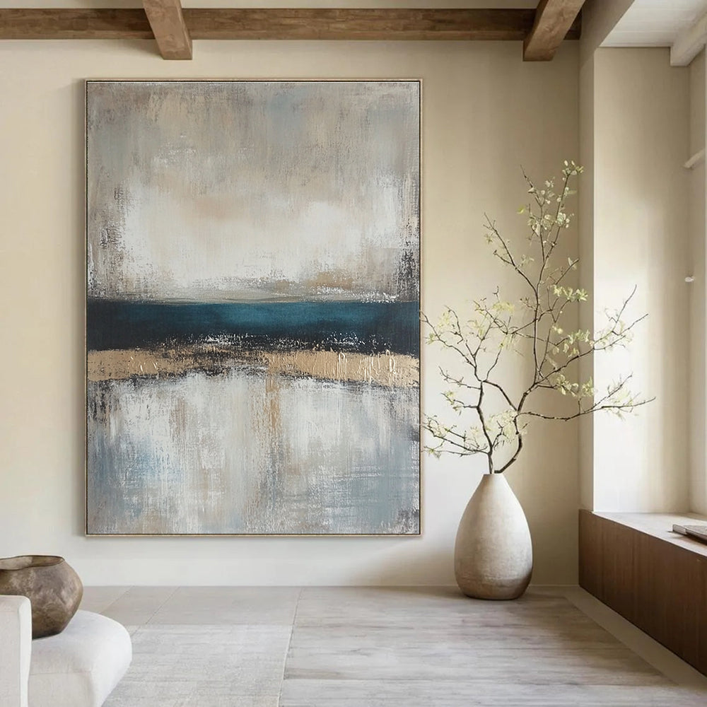 Large abstract painting featuring neutral colors and soft tones of beige gray and blue with a serene horizon line.STSC462