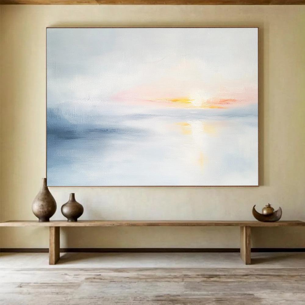 Large abstract painting featuring soft light sky blue and gray tones depicting a serene sunset over calm water on a white background.SC082