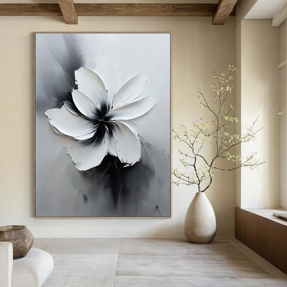 Large abstract white flower painting in black and gray with soft lighting and delicate textures creates an elegant minimalist art piece.STSC516