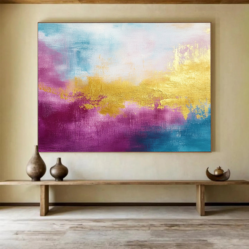 A large abstract painting features gold, magenta, and cyan hues with soft brush strokes and a tranquil water-inspired backdrop.SC322