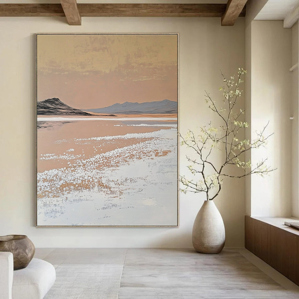 A large abstract painting features white salt crystals on a lake contrasting with textured brushstrokes in light beige and dark gold against a minimalist landscape.STSC1435