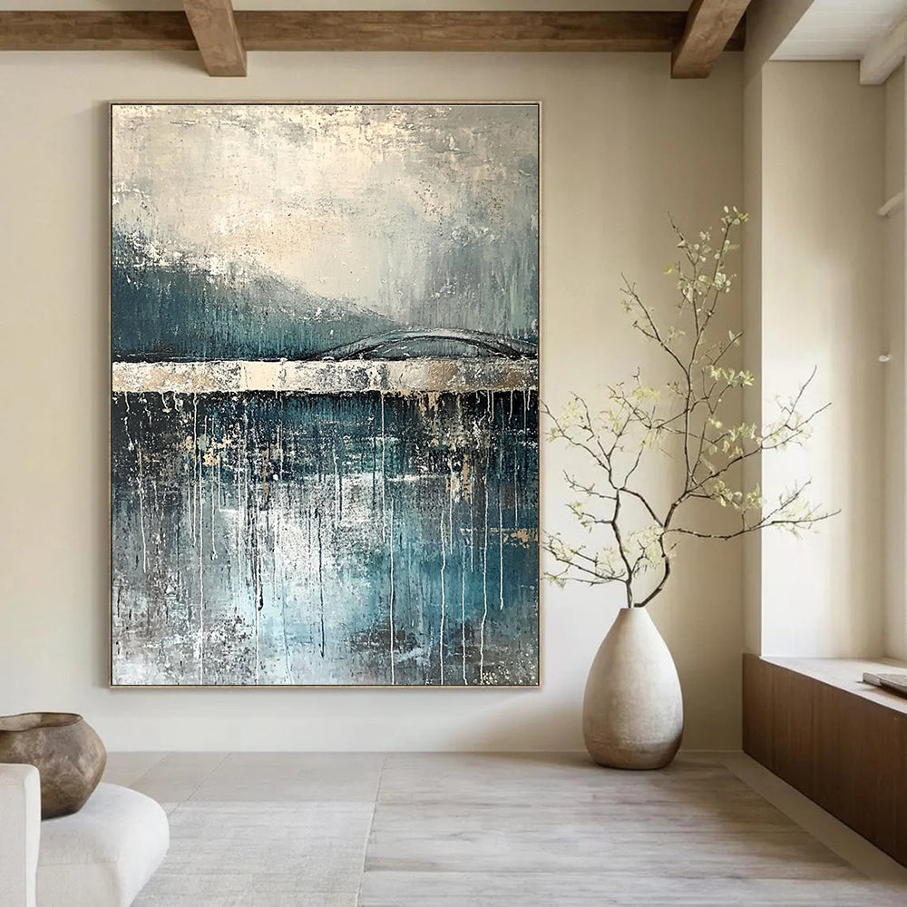 Large abstract painting depicting rain reflections on water with an old bridge in gray and blue tones accented with silver on textured canvas.STSC326