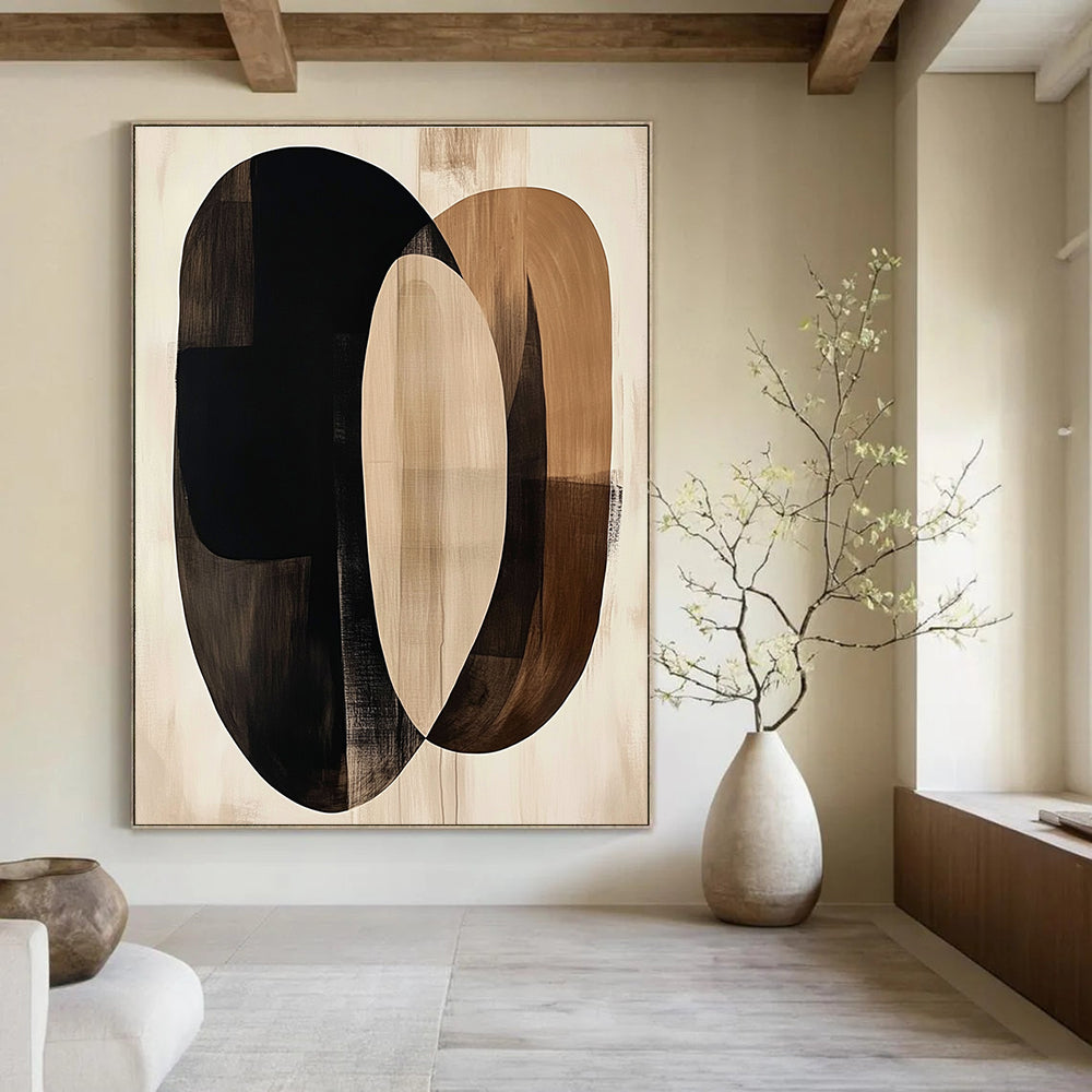 Large abstract artwork featuring fluid beige and black shapes with dark brown ovals on a cream background evokes tranquility through minimalist design.STSC470