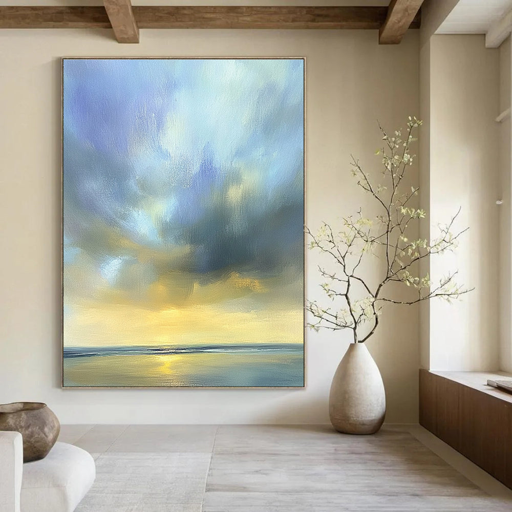 Large abstract oil painting of the sky featuring muted blue light gray and soft clouds over an ocean horizon in beautiful serene colors.STSC201