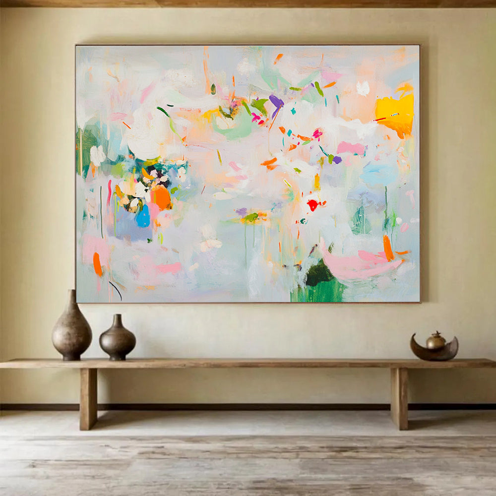 Large abstract painting in soft pastels featuring spring themes with flowers leaves trees and vibrant splashes of color creating a lively atmosphere.SC384