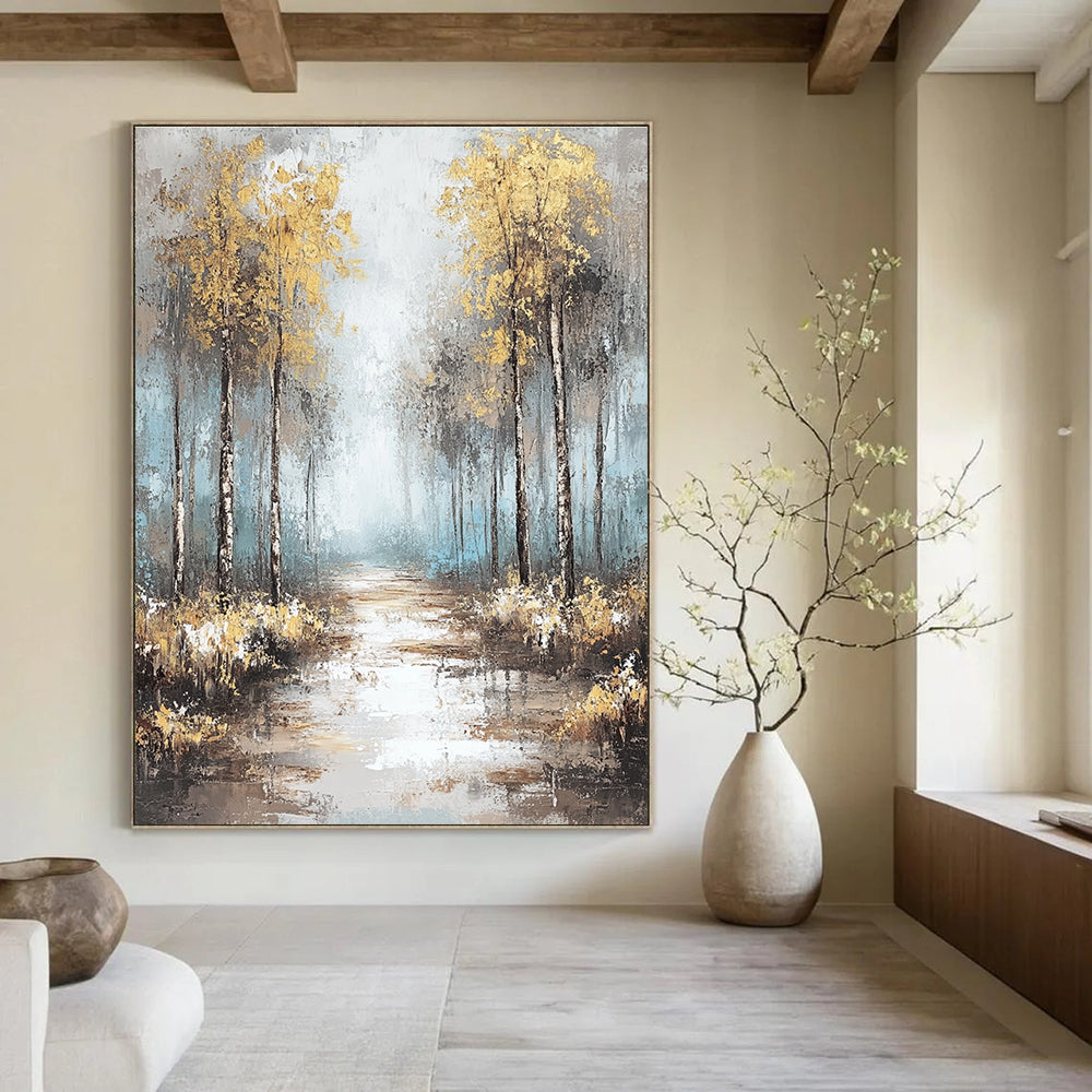 Large abstract painting featuring soft blues and grays with gold leaf accents creating a tranquil misty forest landscape.STSC060