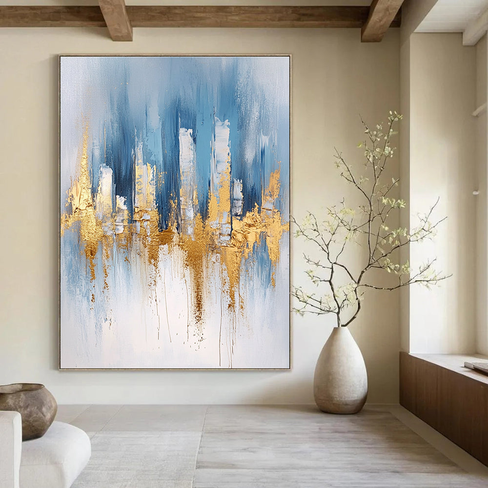 Large abstract blue and gold painting with urban landscape details light gray brushstrokes and elegant gold foil accents on canvas edges.STSC033