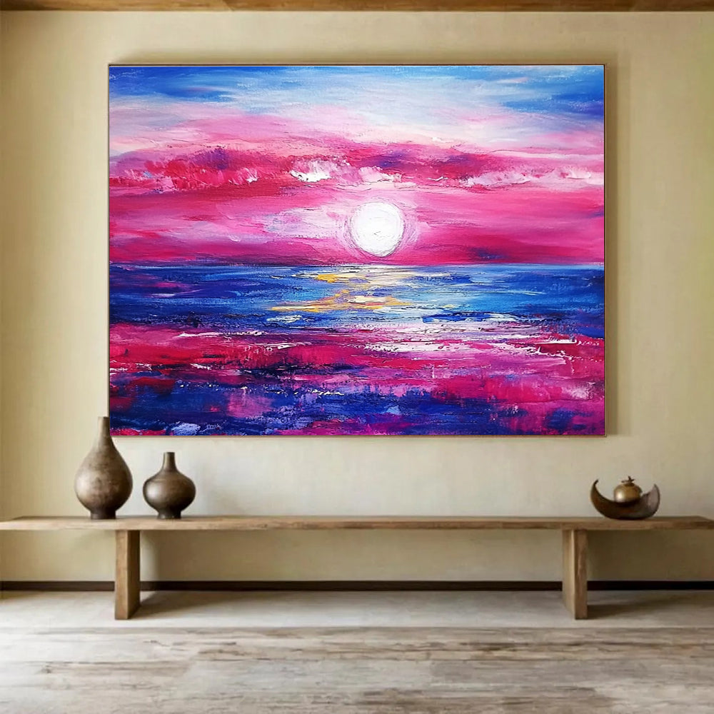 A large abstract painting featuring a pink and blue sunset over the ocean with purple and red clouds by artist Anna Bocek.SC537