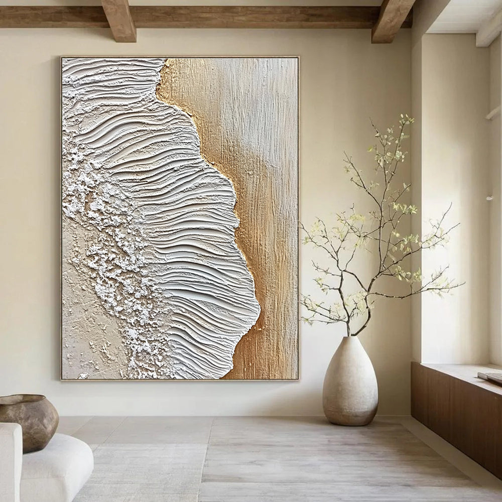 A large abstract painting featuring textured sand and waves in white and beige against an oak wood floor, embodying coastal elegance.STSC946