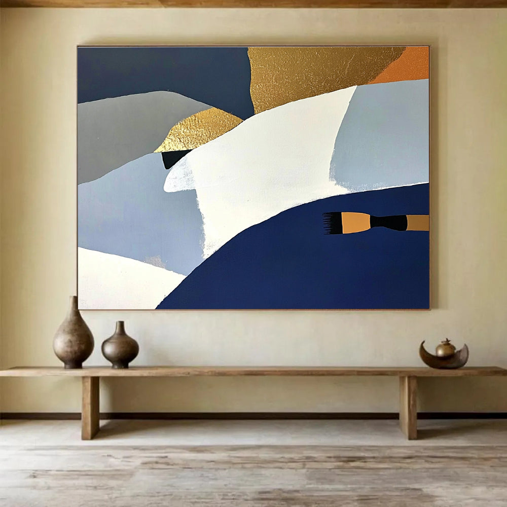 Large abstract painting featuring white blue and gold shapes against a dark gray backdrop with orange details and a soft yellow surface.SC444