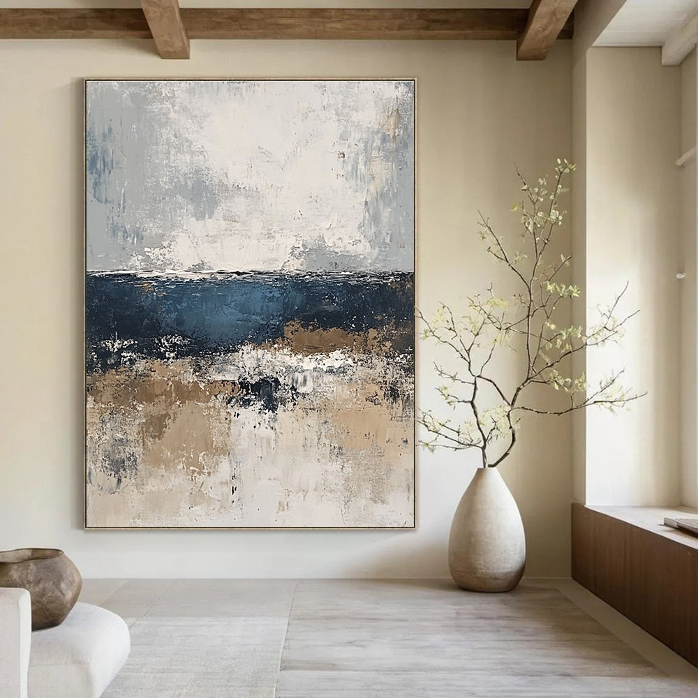 Large abstract painting of the sea in gray and blue tones with accents of beige brown and white for a serene artistic touch.STSC343
