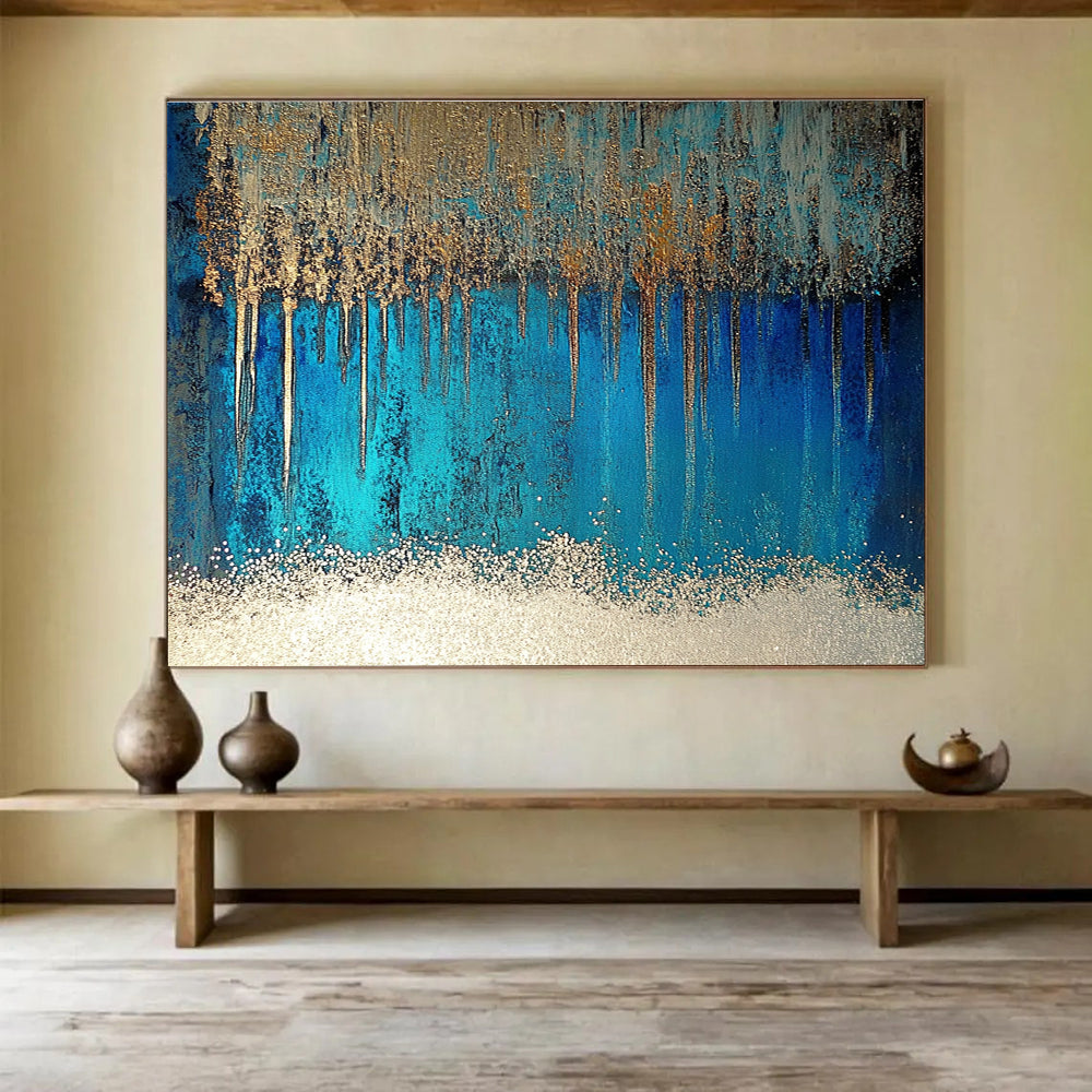 A large abstract painting featuring blue and silver patterns with glittering white sand and a rich brown liquid, accented by a thin silver line.SC346