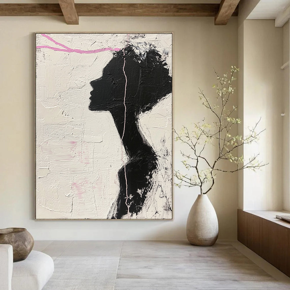 Large abstract painting in black and white featuring a woman’s silhouette with pink accents enhancing her facial features against a textured background.STSC1091