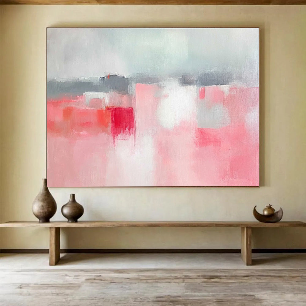 Large abstract painting featuring soft pink and grey tones, white space, sky blue, red accents, and a blurred town background.SC257