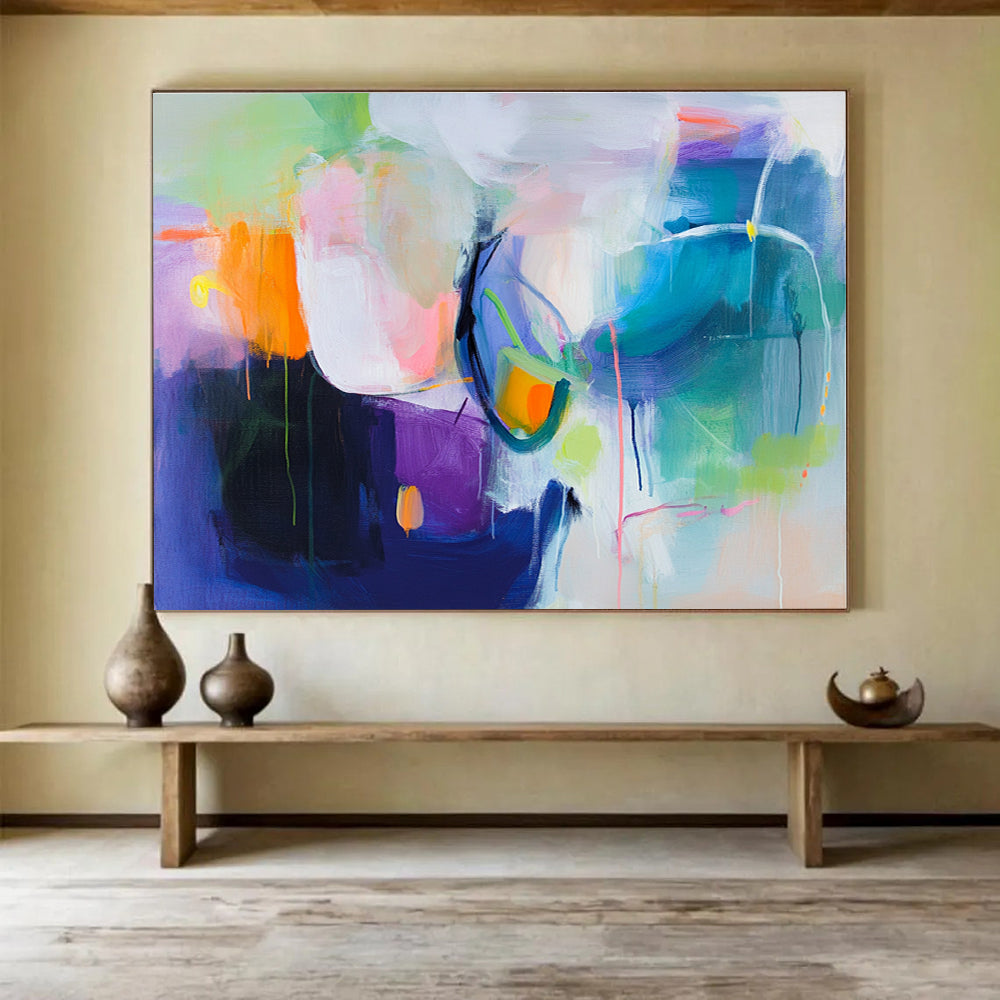 A large abstract painting featuring a colorful background with soft shapes and bold colors, evoking movement and energy with hints of pink blue green and more.SC312