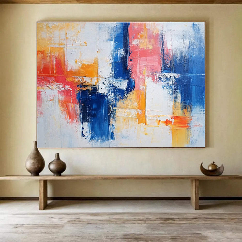 Large abstract painting with vibrant blue and red brush strokes on white, featuring yellow highlights and textured layers that evoke nostalgia and joy.SC263