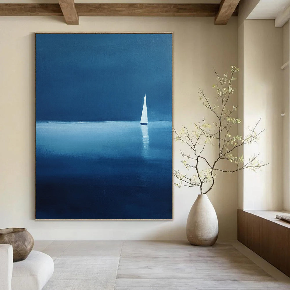Large abstract painting of a serene sailboat on calm waters using blue and white shades against a dark backdrop evoking tranquility and solitude.STSC1086