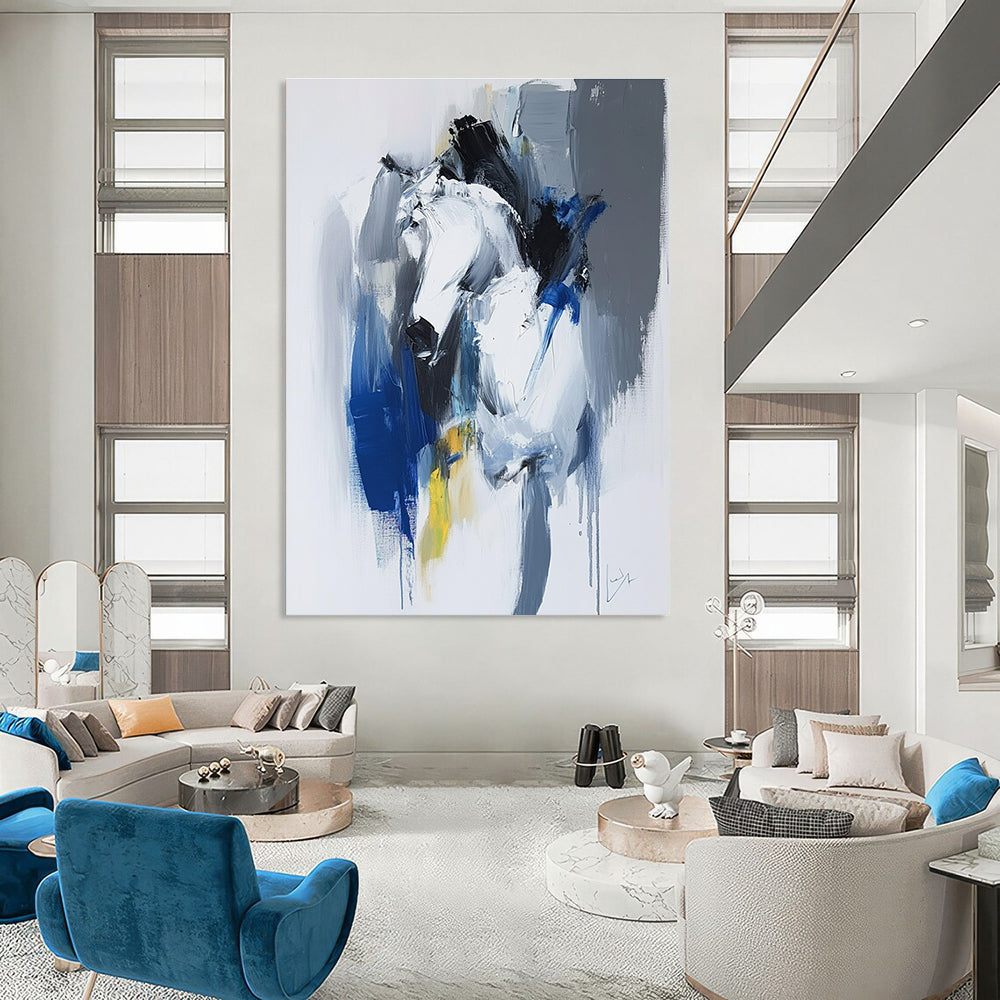 Large abstract painting in blue and white with dynamic brushstrokes reveals movement and emotion featuring elements of strength and energy.STSC036