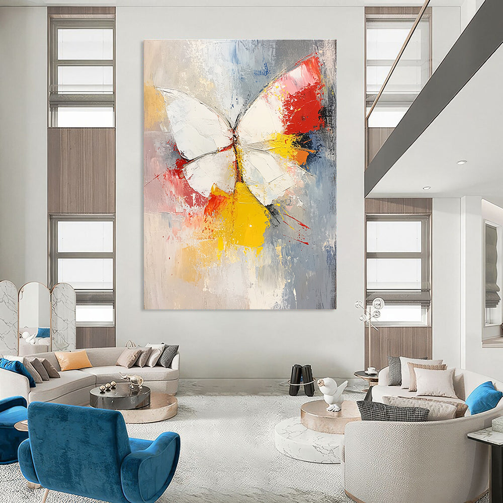 Large abstract painting featuring a white and red butterfly with vibrant yellow feathers set against a soft gray and pink background.STSC552