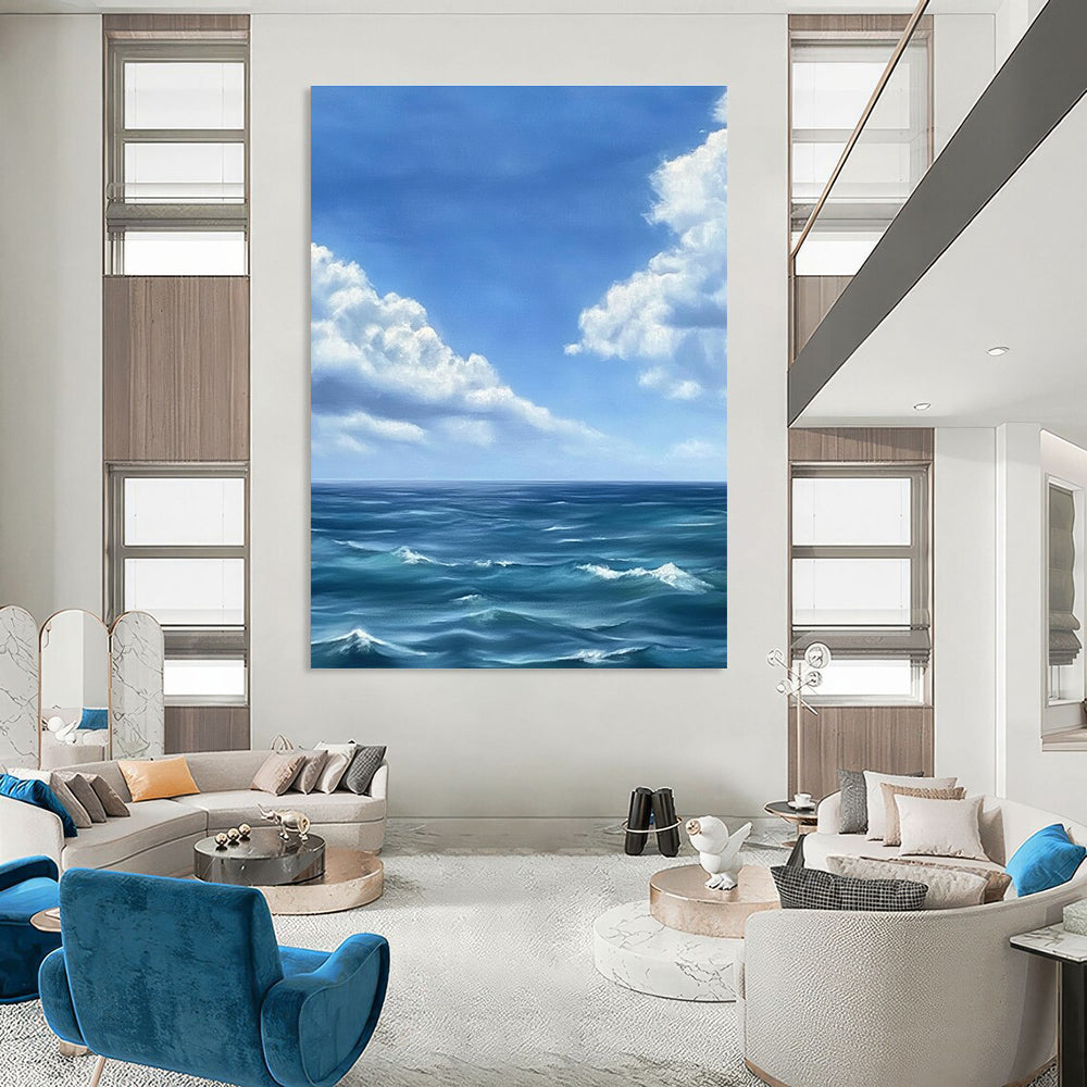 Large abstract painting depicting a tranquil ocean scene with gentle waves under a vast blue sky and soft white clouds in Monet's style.STSC1215