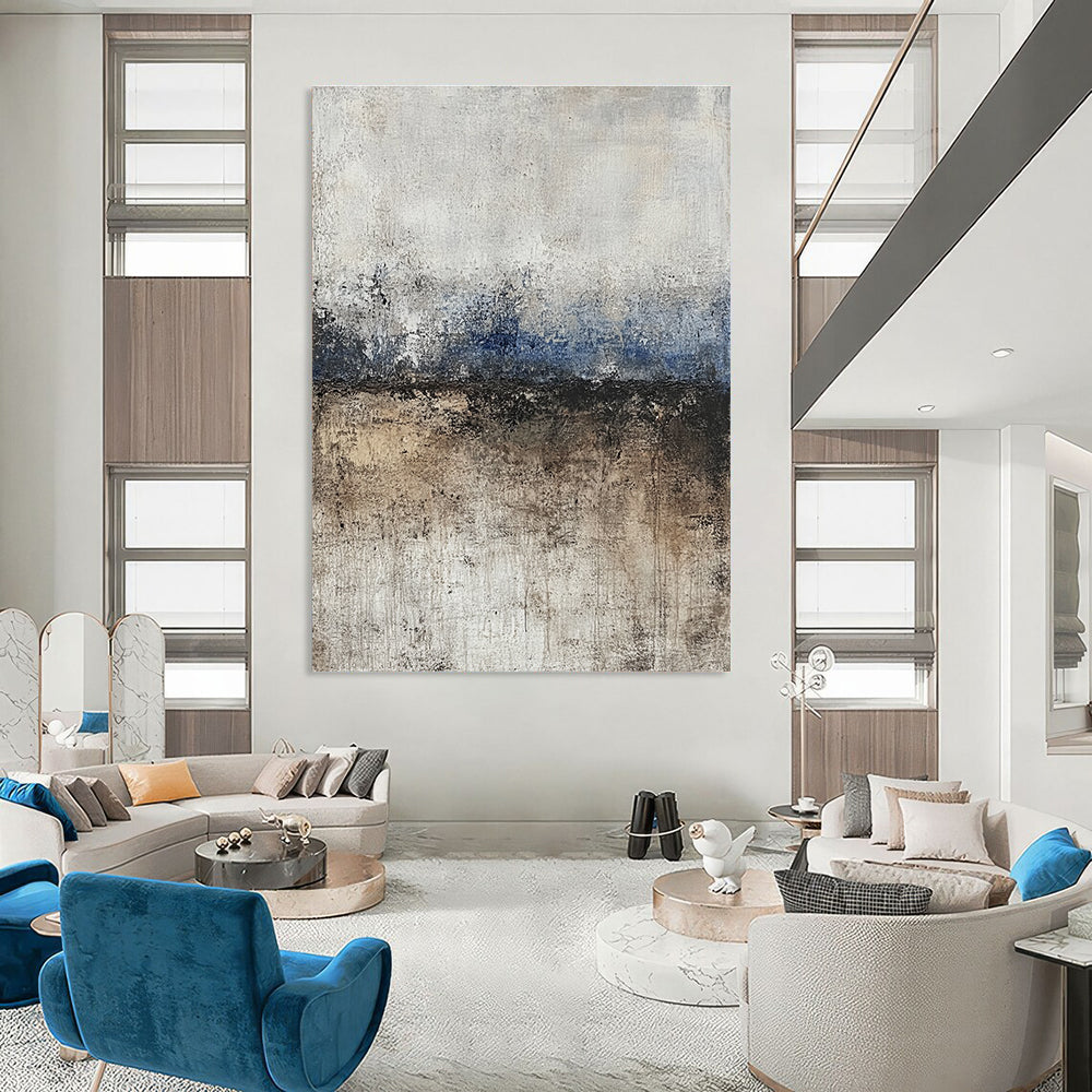 Large abstract painting featuring soft edges and subtle color transitions of beige blue-gray and brown with a path leading to tranquil water.STSC125