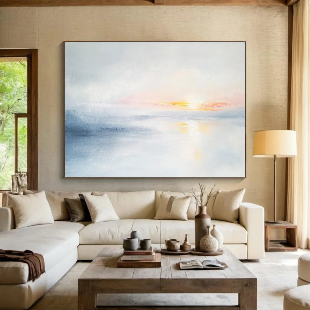 Large abstract painting featuring soft light sky blue and gray tones depicting a serene sunset over calm water on a white background.SC082