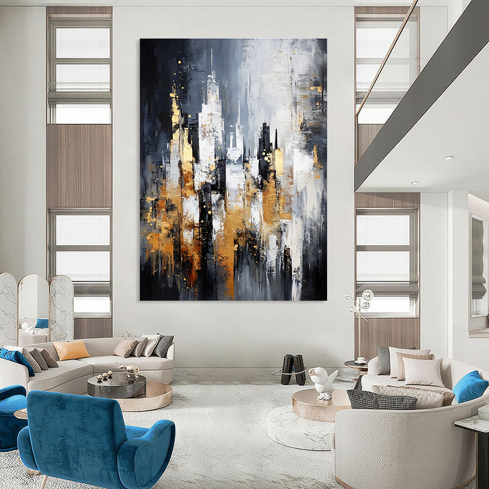 Large abstract painting of a cityscape in gray and white with gold accents on a dark background featuring neutral tones.STSC282