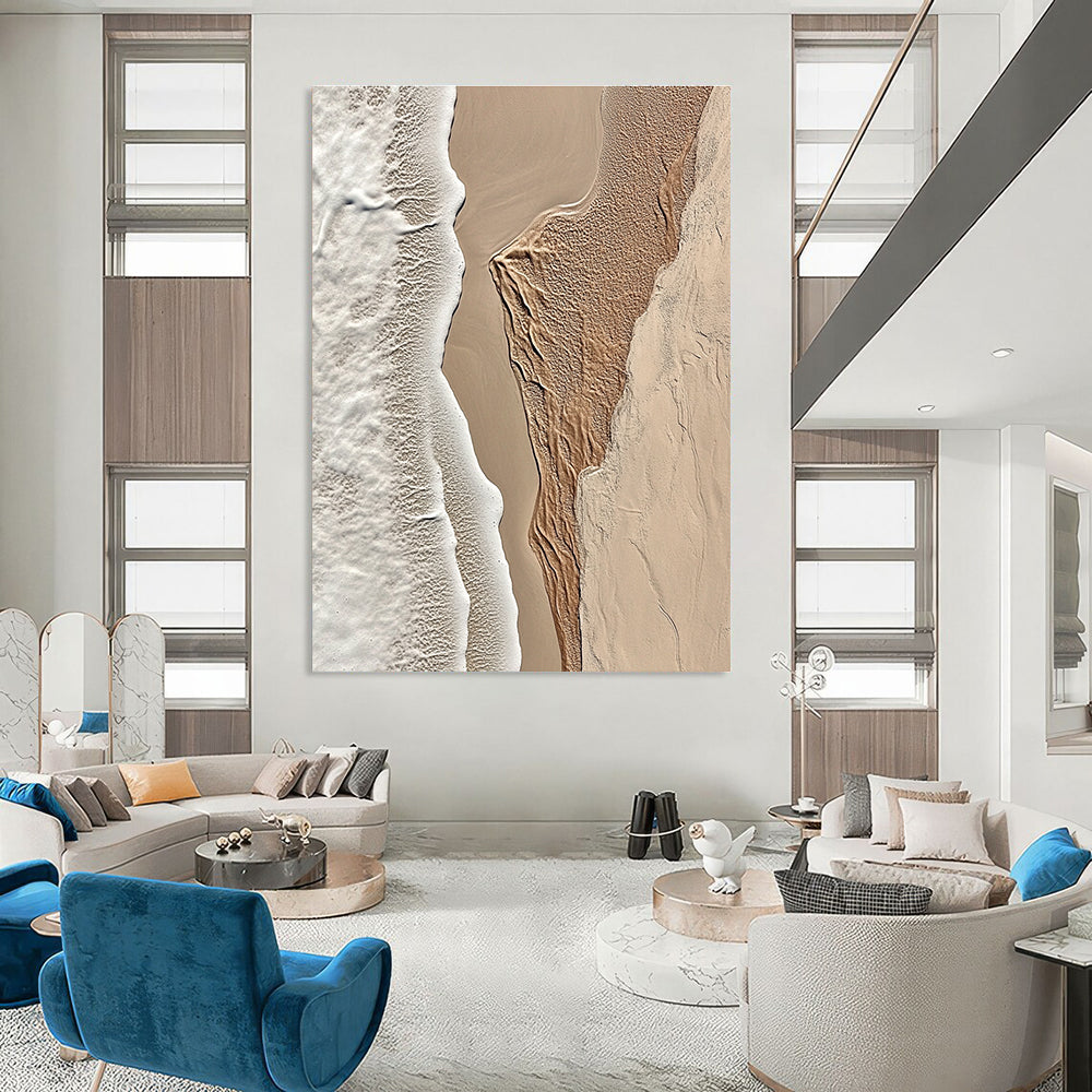 A large abstract painting featuring intricate textures of beige sand and white waves capturing the tranquility of coastal landscapes.STSC1294