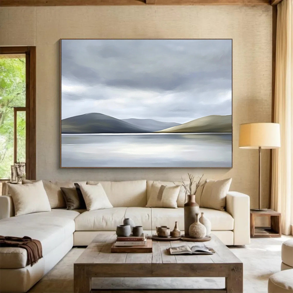 Large abstract painting of the Scottish Highlands featuring muted colors soft light grey sky white clouds and a serene lake in the foreground.SC131