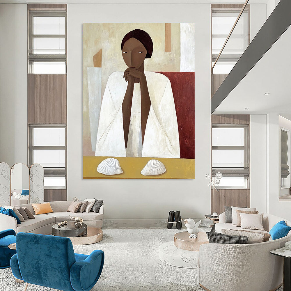 A large abstract painting featuring an African woman in a white cloak sitting on a yellow table with shells in daylight.STSC1115