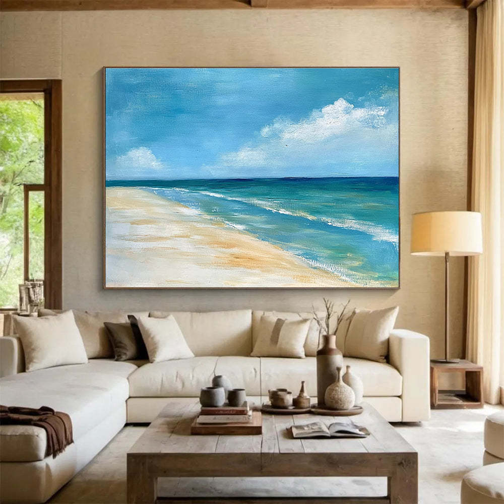 A large abstract painting of the ocean sky and sandy beach in muted blue tones with green accents and soft clouds for a serene ambiance.SC362