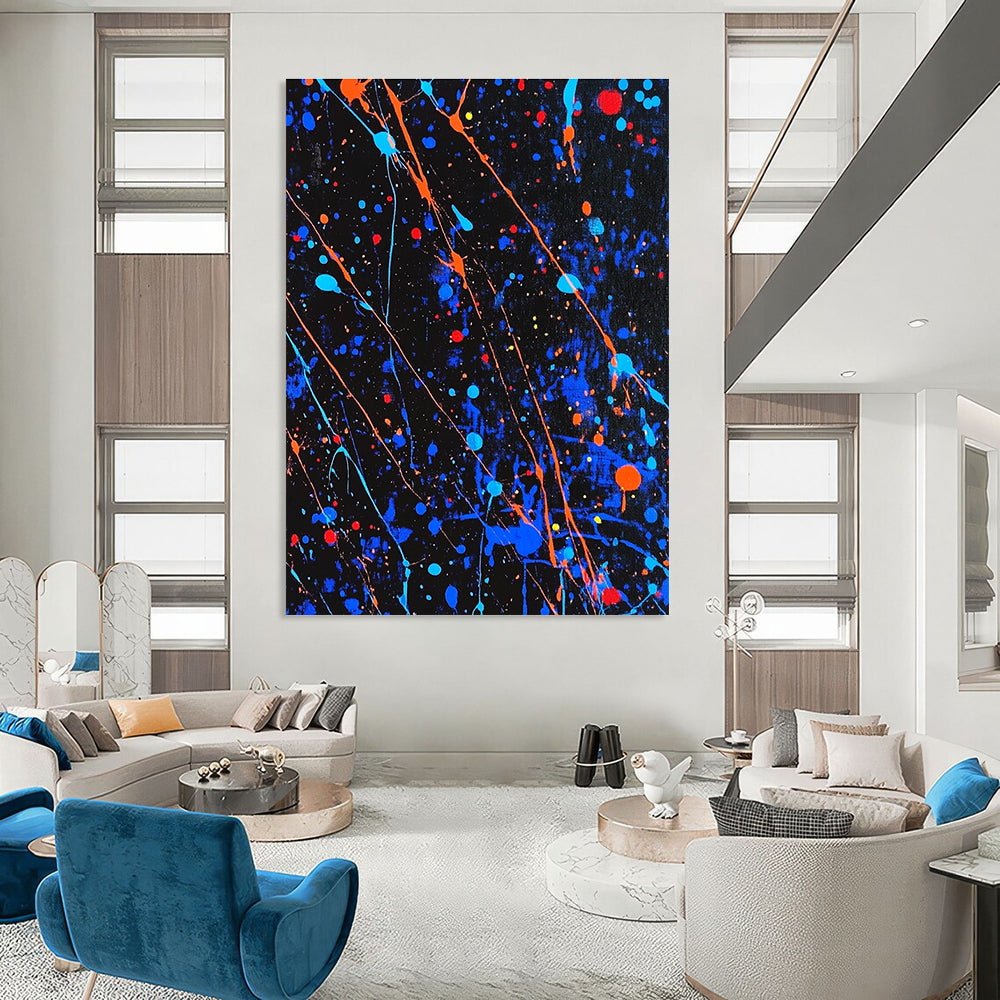 Large abstract painting featuring blue and black splatters with vibrant orange and red highlights for a dynamic artistic statement.STSC1406