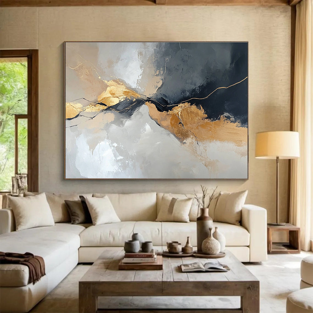 Large abstract painting with an aerial view in gray and beige colors featuring minimalistic shapes and brush strokes enhanced with gold accents.SC104