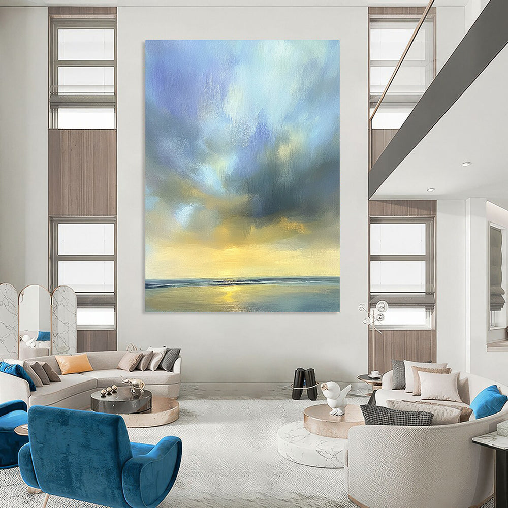 Large abstract oil painting of the sky featuring muted blue light gray and soft clouds over an ocean horizon in beautiful serene colors.STSC201