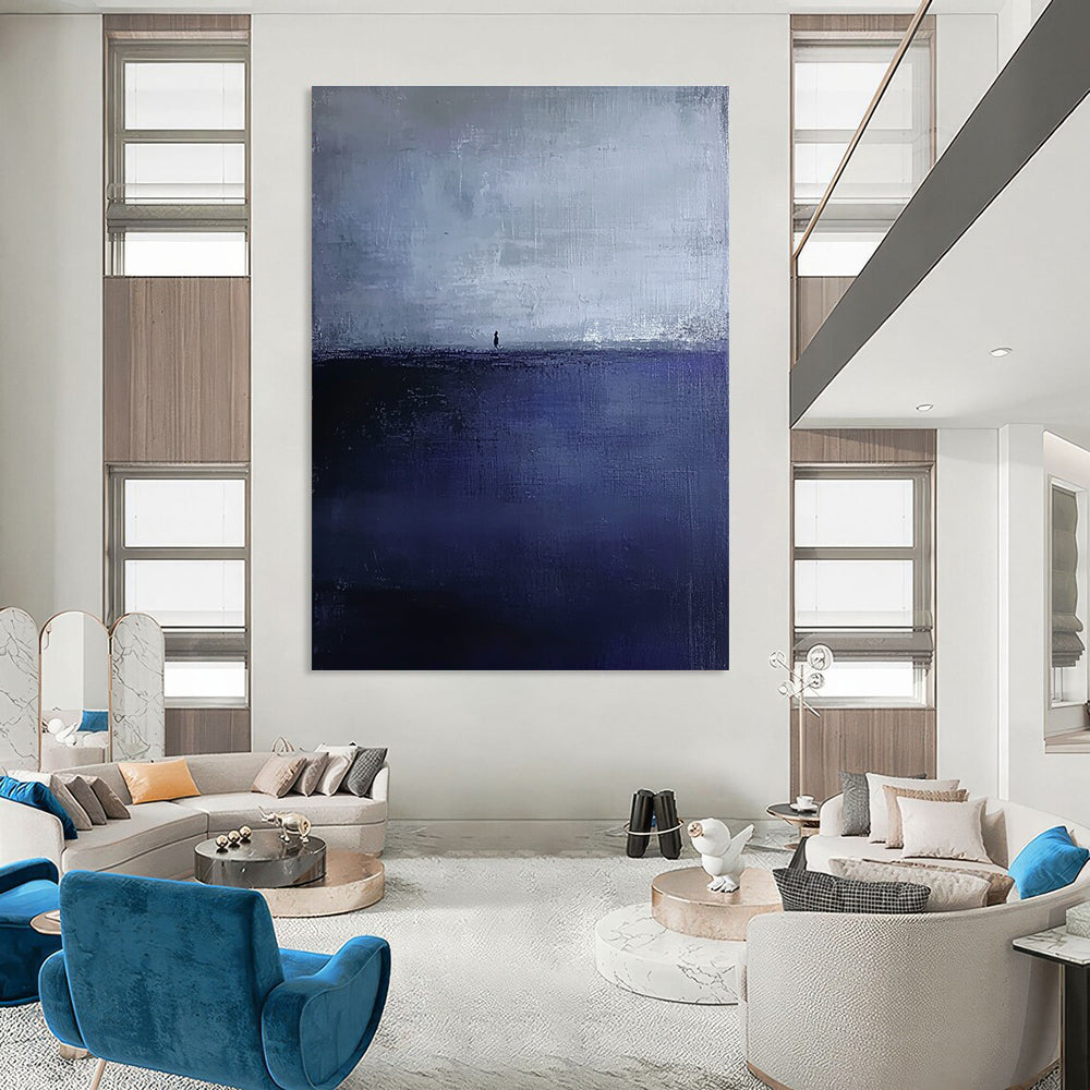 Large abstract painting in dark blue and gray depicting an atmospheric seascape with a small silhouette on the distant horizon.STSC1085