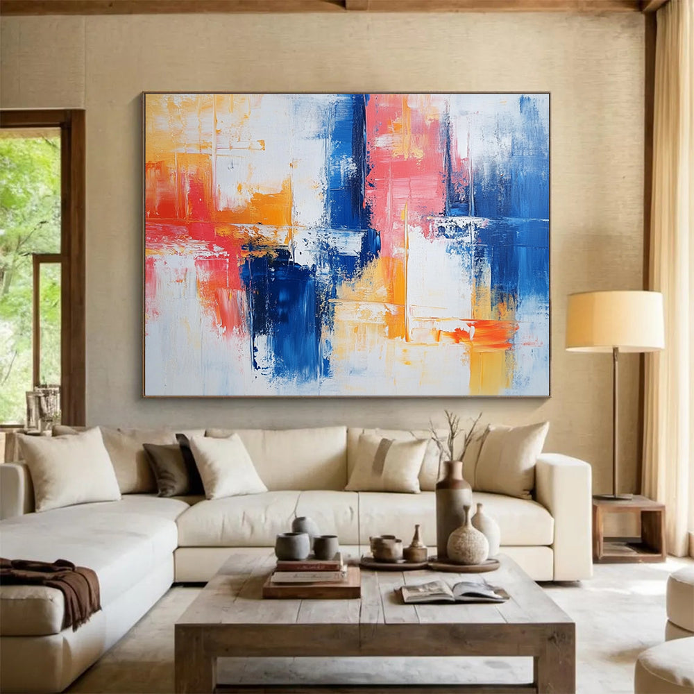 Large abstract painting with vibrant blue and red brush strokes on white, featuring yellow highlights and textured layers that evoke nostalgia and joy.SC263
