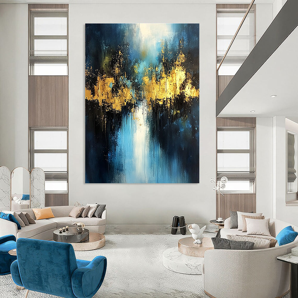 Large abstract painting with light blue and dark gold colors featuring atmospheric brushstrokes gold foil embellishments and a mysterious night scene.STSC399