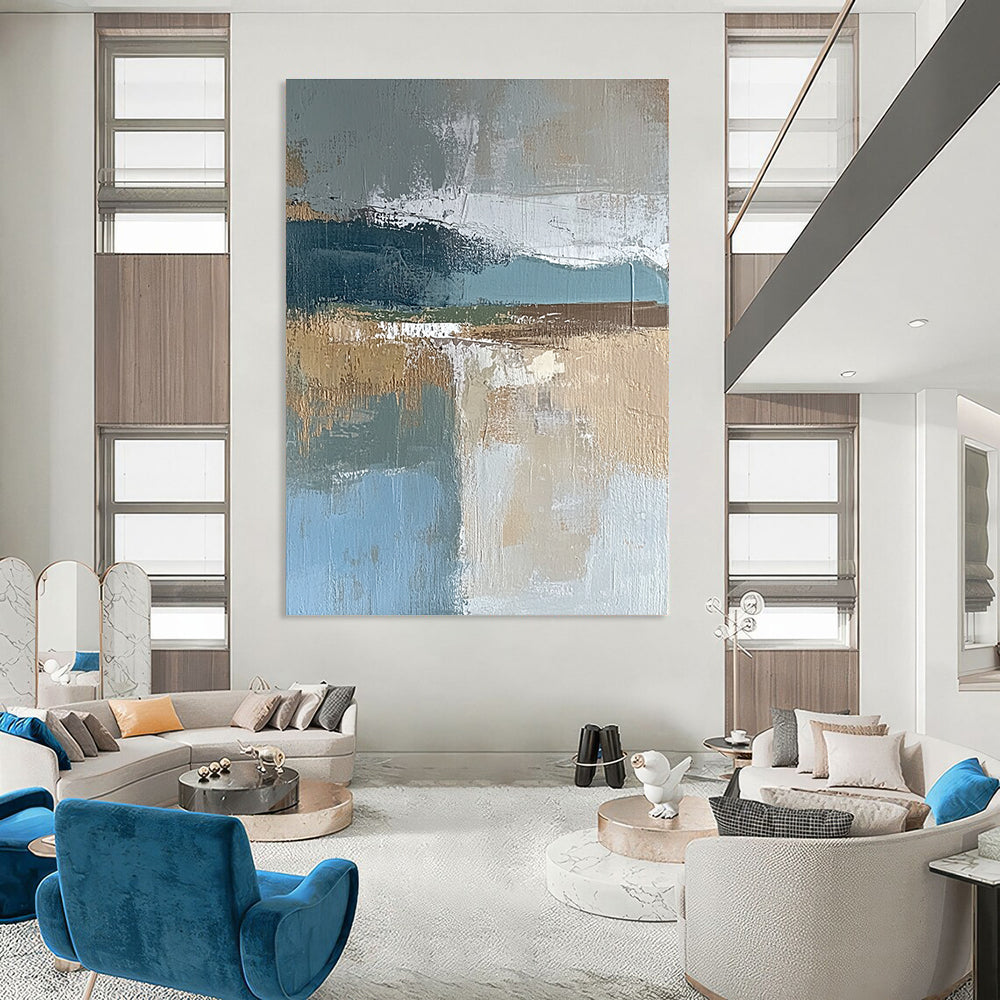 Large abstract painting featuring muted blue gray and brown tones with textured brushstrokes and earthy accents in green and beige.STSC563