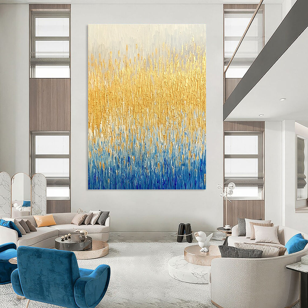 Large abstract painting of a textured wheat field in gold and blue hues showcasing fine art style and neutral tones.STSC291