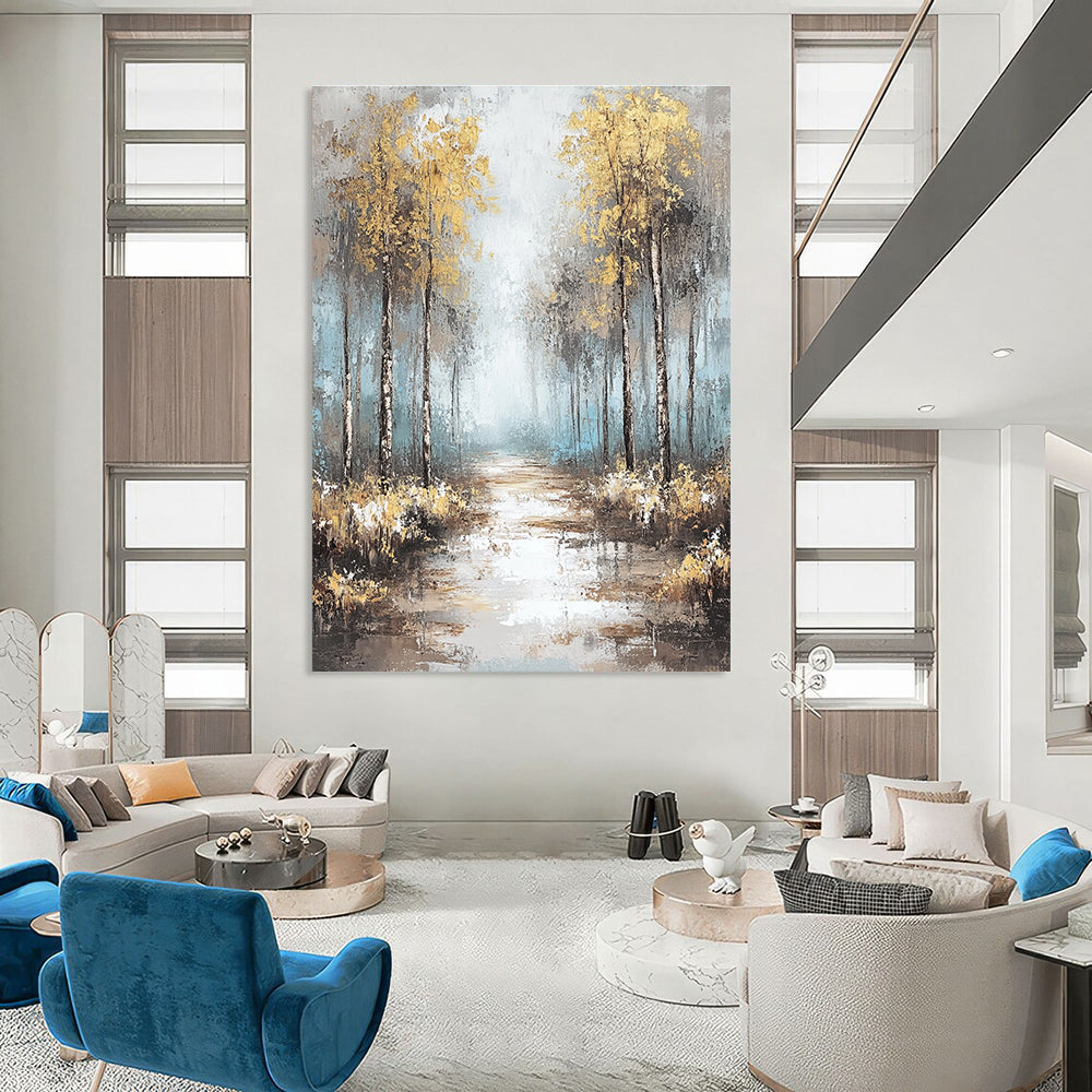 Large abstract painting featuring soft blues and grays with gold leaf accents creating a tranquil misty forest landscape.STSC060