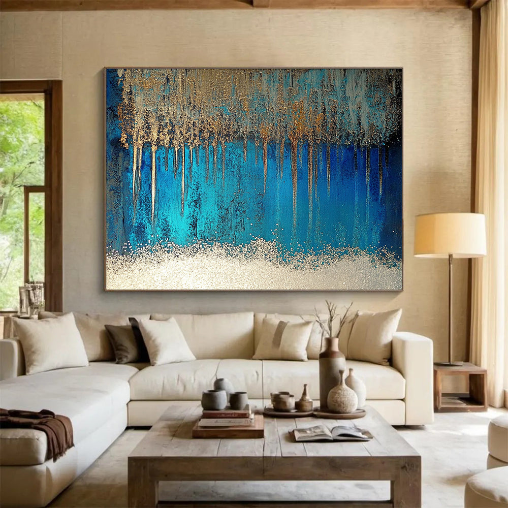 A large abstract painting featuring blue and silver patterns with glittering white sand and a rich brown liquid, accented by a thin silver line.SC346