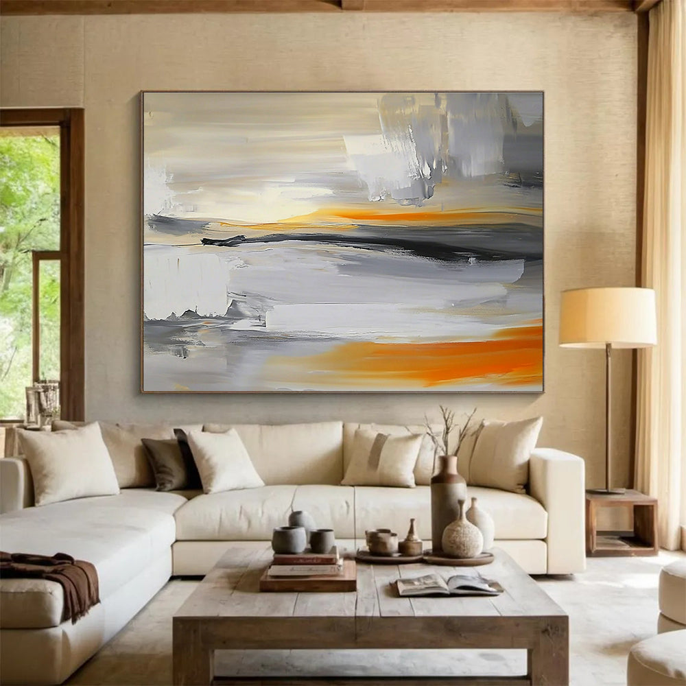 Large abstract painting featuring a grey, white, and orange sky with a blurred horizon and rocks below in a minimalist style.SC175