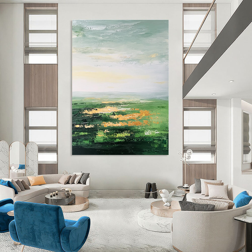Large abstract painting featuring a vast green landscape soft sky gold accents and thick brush strokes for a dreamy blurry effect.STSC887