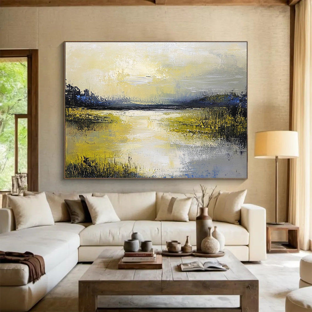 Large abstract painting featuring a serene lake and sky in soft yellow green blue and gray tones with thick textured paint.SC078
