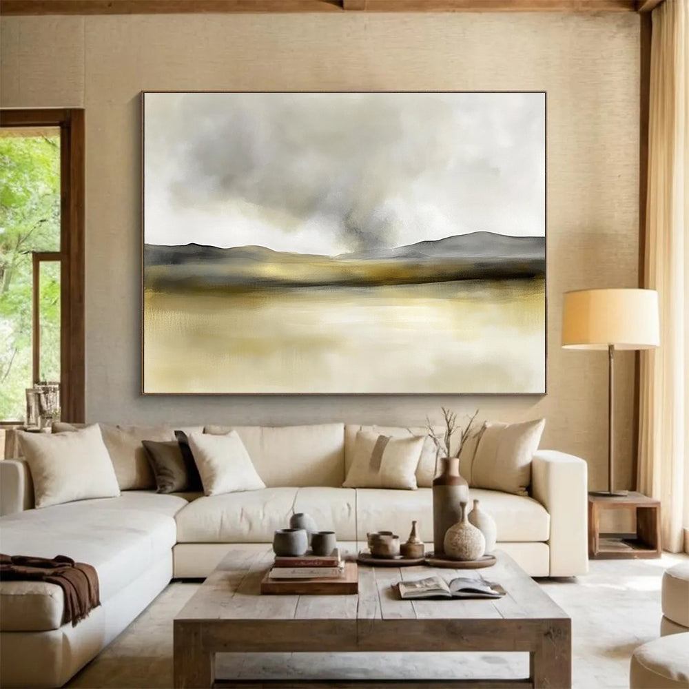 Large abstract painting in soft watercolors featuring neutral beige and gray tones with yellow accents and distant rolling hills under smoke.SC075