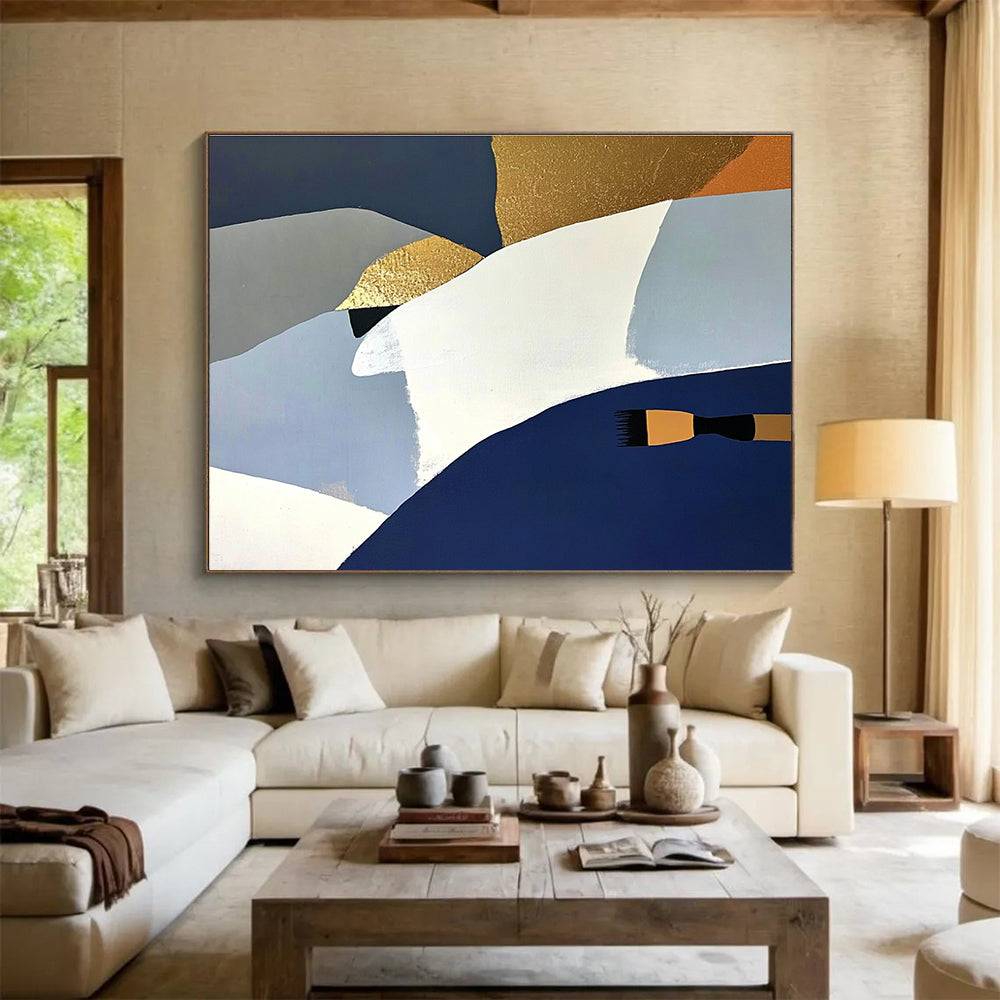 Large abstract painting featuring white blue and gold shapes against a dark gray backdrop with orange details and a soft yellow surface.SC444