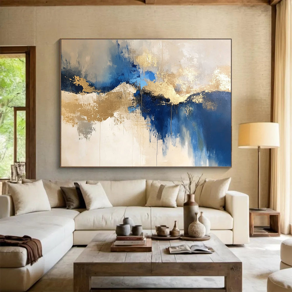 Large abstract blue and gold painting on a white background with elegant beige tones, ideal for modern decor and artistic spaces.SC022