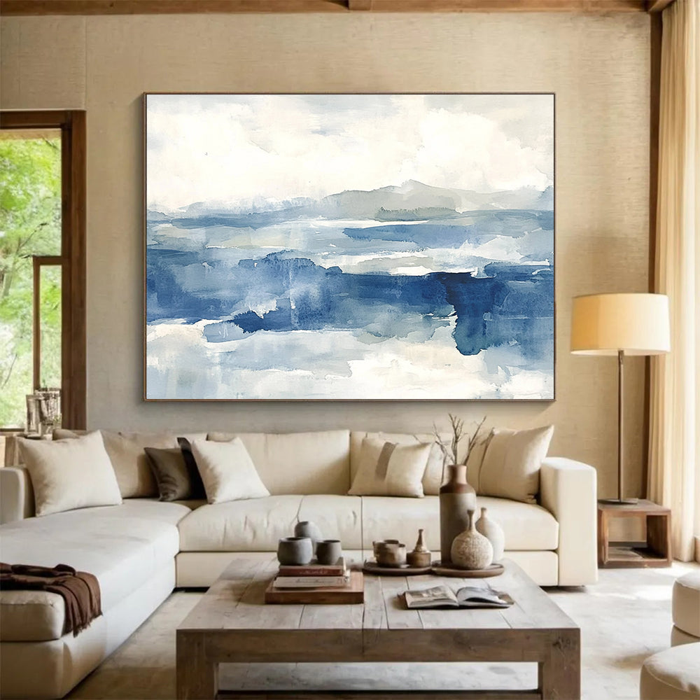 Large abstract painting of the sea features shades of blue and gray with soft clouds, evoking a stormy atmosphere and depth.SC289
